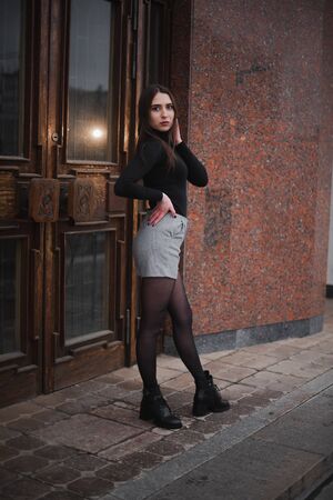 Street urban shooting. Girl on a textured background in the city.の写真素材