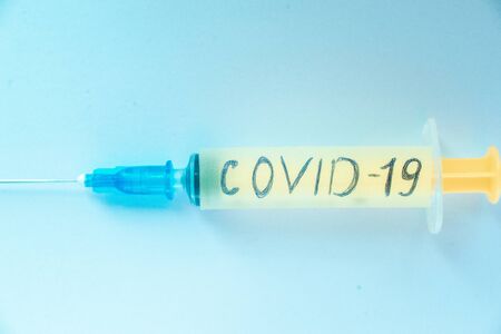 Syringe with the inscription coronavirus on a light background. Concept.の写真素材