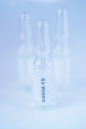 Coronavirus vaccine macro ampoule concept. Blurred background photo.の写真素材