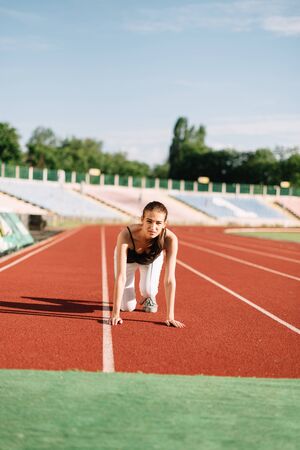 Girl athlete on the treadmill at the start before running.の写真素材
