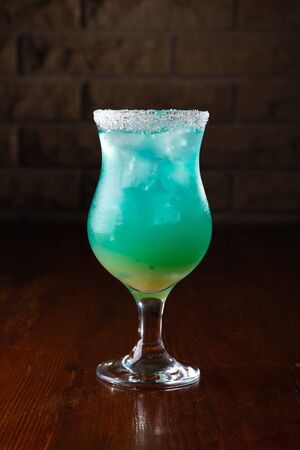 Refreshing sea blue cocktail on a wooden background.の写真素材