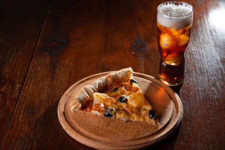 Pizza on a wooden dark background in a bar.の写真素材