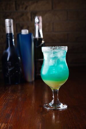 Refreshing sea blue cocktail on a wooden background.の写真素材