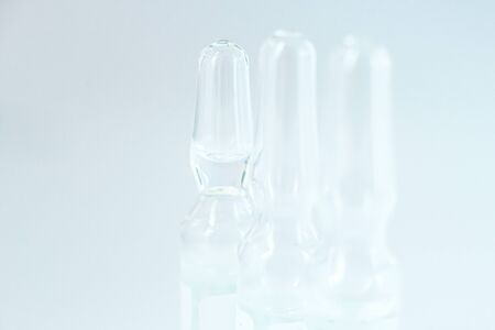 Coronavirus vaccine macro ampoule concept. Blurred background photo.