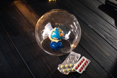 Globe under a glass bell. The concept of isolating the world during the coronavirus pandemic.の写真素材