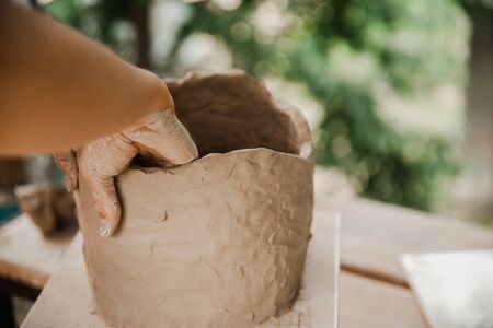 Handmade clay brown pots with blurry background.の写真素材