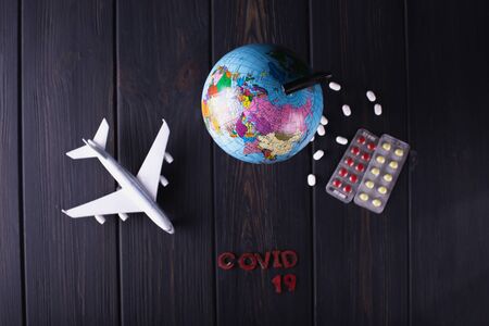 Globe with pills on a dark blurry background. World pandemic concept COVID-19の写真素材