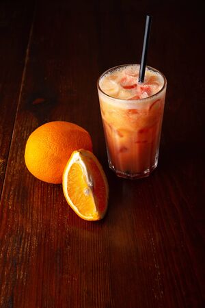 Homemade orange cocktail on a wooden dark background.の写真素材