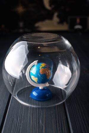 Earth under a glass bell. Quarantine, pandemic concept in the world COVID-19.の写真素材