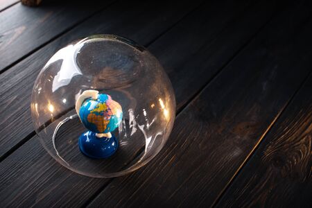 Earth under a glass bell. Quarantine, pandemic concept in the world COVID-19.の写真素材