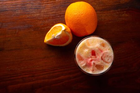 Homemade orange cocktail on a wooden dark background.の写真素材
