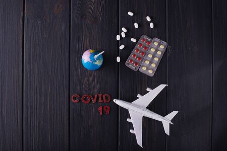 Globe with pills on a dark blurry background. World pandemic concept COVID-19の写真素材