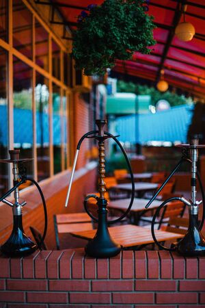 Stylish wooden hookah in the evening on a summer terrace in a cafe.の写真素材