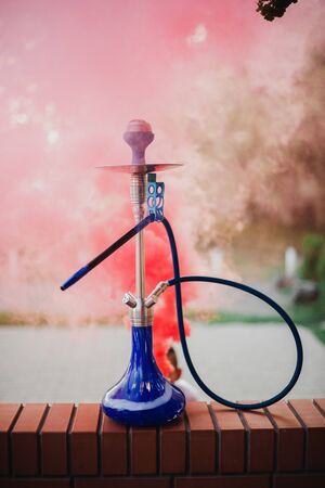 Hookah outdoors on a background of colored smoke.の写真素材