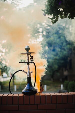Hookah outdoors on a background of colored smoke.の写真素材