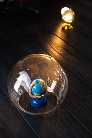Earth under a glass bell. Quarantine, pandemic concept in the world COVID-19.の写真素材
