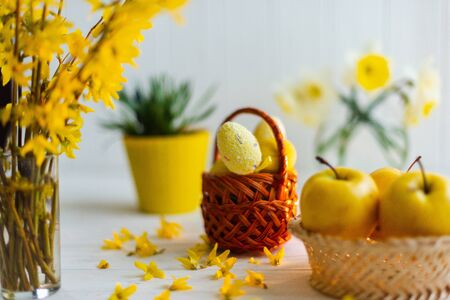 Yellow easter eggs in a basket on a white background.の写真素材