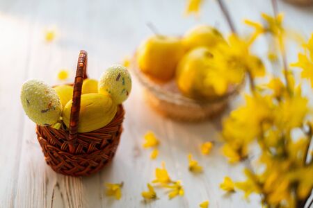 Yellow easter eggs in a basket on a white background.の写真素材