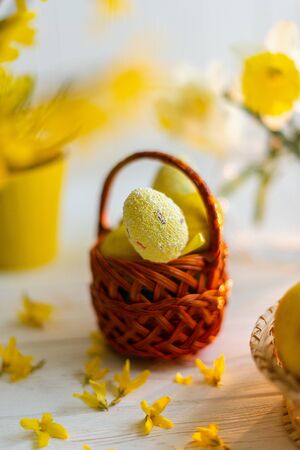 Yellow easter eggs in a basket on a white background.の写真素材