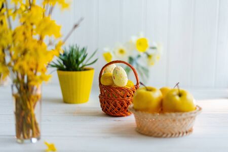 Yellow easter eggs in a basket on a white background.の写真素材