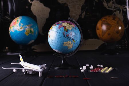 Globe with pills on a dark blurry background.の写真素材