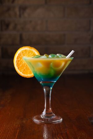 Orange cocktail on a wooden background in a bar.の写真素材