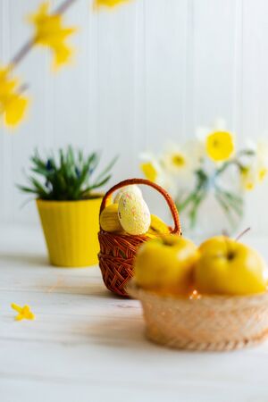 Yellow easter eggs in a basket on a white background.の写真素材