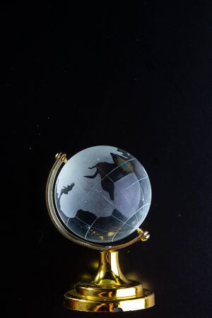 Glass globe on a black matte background.の写真素材