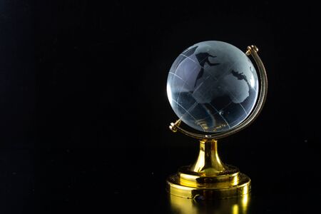 Glass globe on a black matte background.の写真素材