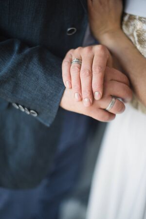 Groom and bride hands rings on blurry background..の写真素材