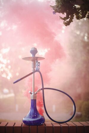 Hookah outdoors on a background of colored smoke.の写真素材