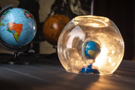 Earth under a glass bell. Quarantine, pandemic concept in the world COVID-19.の写真素材