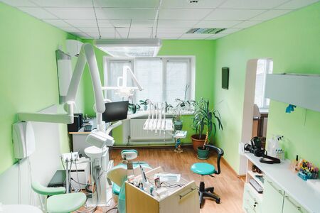 Modern Dental Office with green walls and dental equipment.の写真素材
