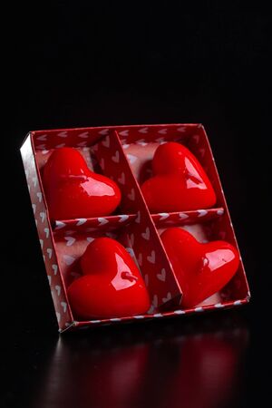 Red scented candles hearts on a black background.の写真素材
