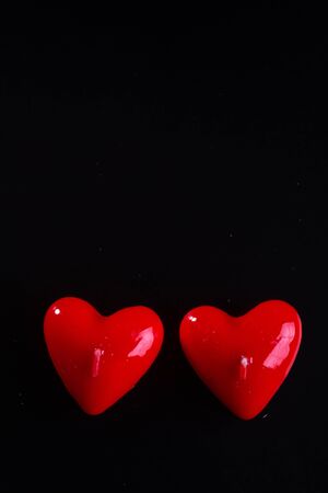 Red scented candles hearts on a black background.の写真素材