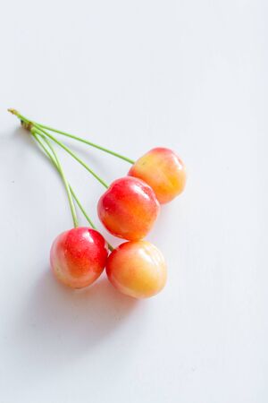 Sweet cherry berries on a white paper background isolate.の写真素材