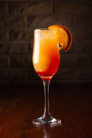 Orange cocktail on a wooden background in a bar.の写真素材