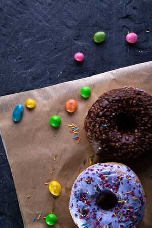 Donuts on a wooden board on a blue concrete background.の写真素材