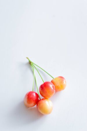 Sweet cherry berries on a white paper background isolate.の写真素材
