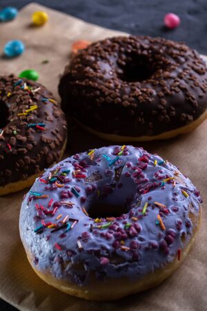 Donuts on a wooden board on a blue concrete background.の写真素材