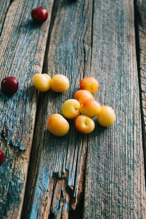 Fresh homemade ripe cherries on a wooden old background. Summer still life.の写真素材