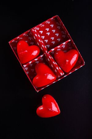 Red scented candles hearts on a black background.の写真素材