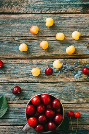 Fresh homemade ripe cherries on a wooden old background. Summer still life.の写真素材