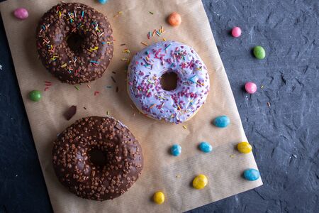 Donuts on a wooden board on a blue concrete background.の写真素材