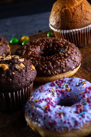 Donuts on a wooden board on a blue concrete background.の写真素材