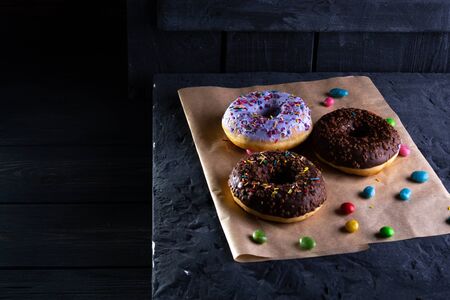 Donuts on a wooden board on a blue concrete background.の写真素材