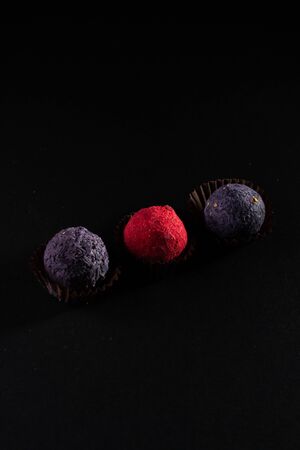 Colored round candies on a dark background.の写真素材