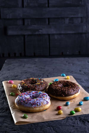 Donuts on a wooden board on a blue concrete background.の写真素材