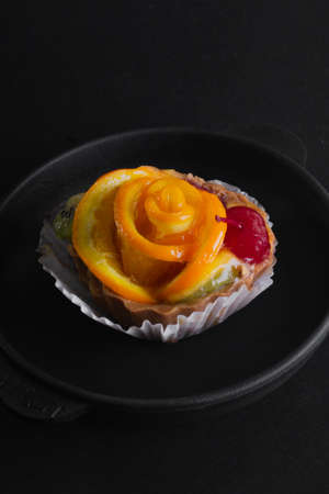 Cheese dessert with orange on a black background.の写真素材