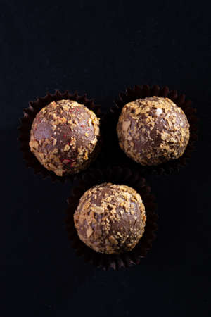 Colored round candies on a dark background.